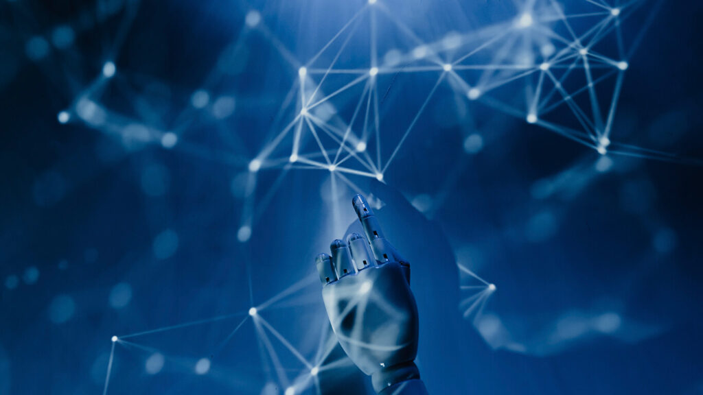 Na imagem, uma mão robótica em meio a dados, simbolizando tudo o que a inteligência artificial ensina sobre o futuro e o que nos espera.