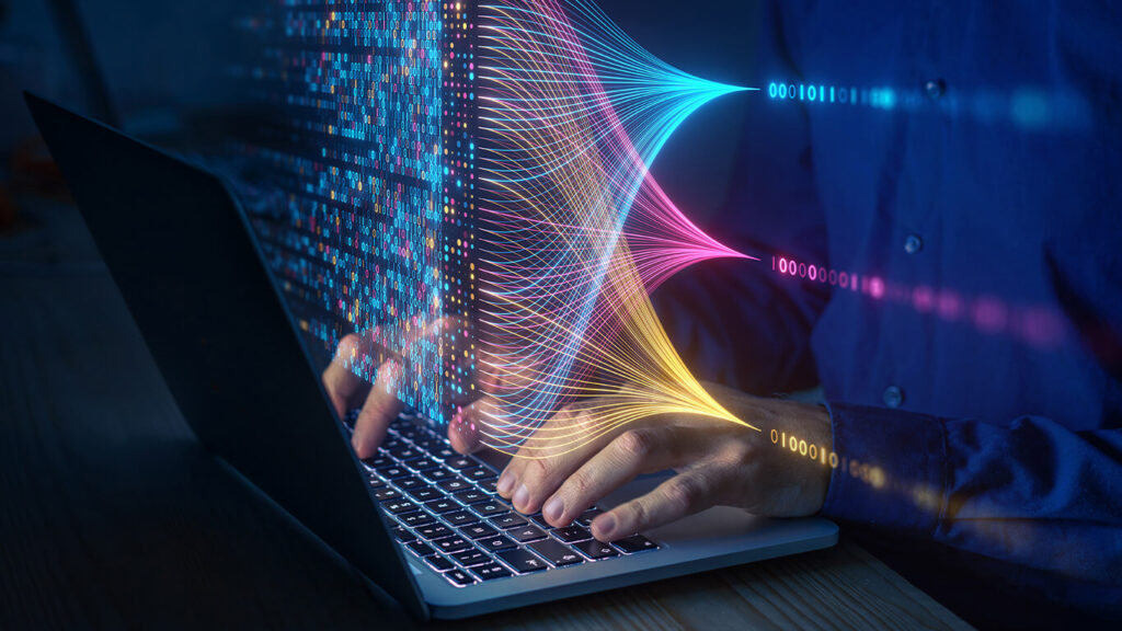 Imagem ilustrativa de um profissional das áreas de Engenharia de Sftware e Data Science e Analytics trabalhando, com dados e números em cima do computador.
