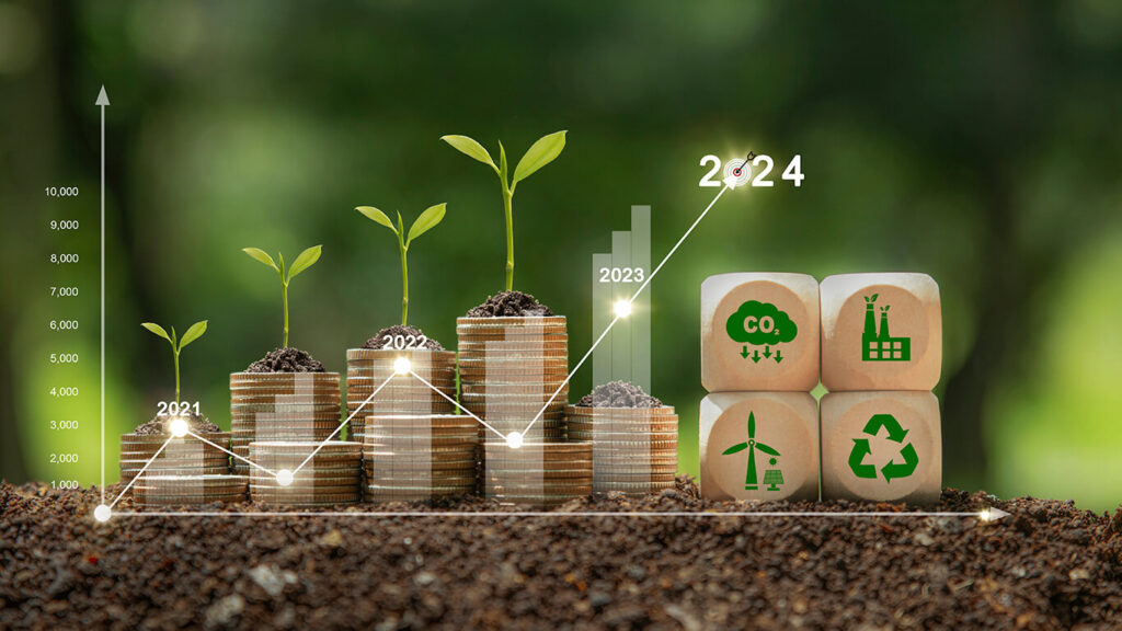 Moedas empilhadas sobre terra, com plantas em volta delas representando o 'ambiental', enquanto tem um gráfico escalonado que relaciona questões ambientais com crescimento econômico
